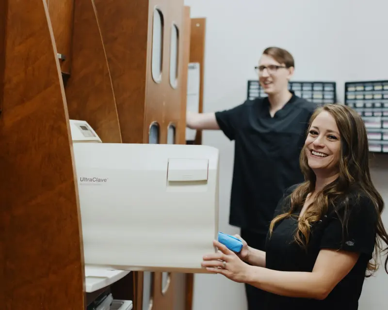 Two Hilltop team members at the sterilization station